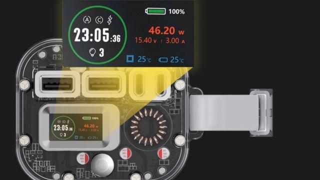 A close-up of an electronic device showcasing its internal components and a detailed display screen. The screen shows the time (23:05), a battery icon at 100%, power usage (46.20W), input (15.40V, 3.00A), and temperature readings (25°C).