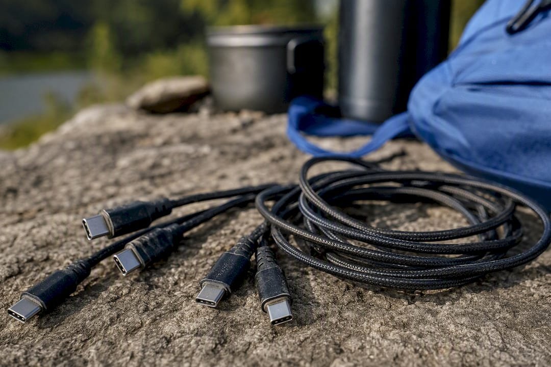 Close-up of USB-C charging cables on wooden table