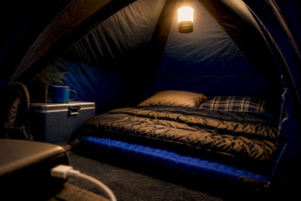 Tent interior illuminated by overhead lantern