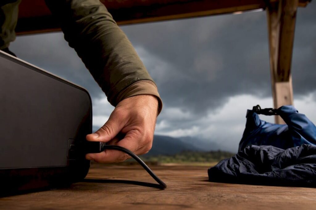 Camper unplugging gear before storm