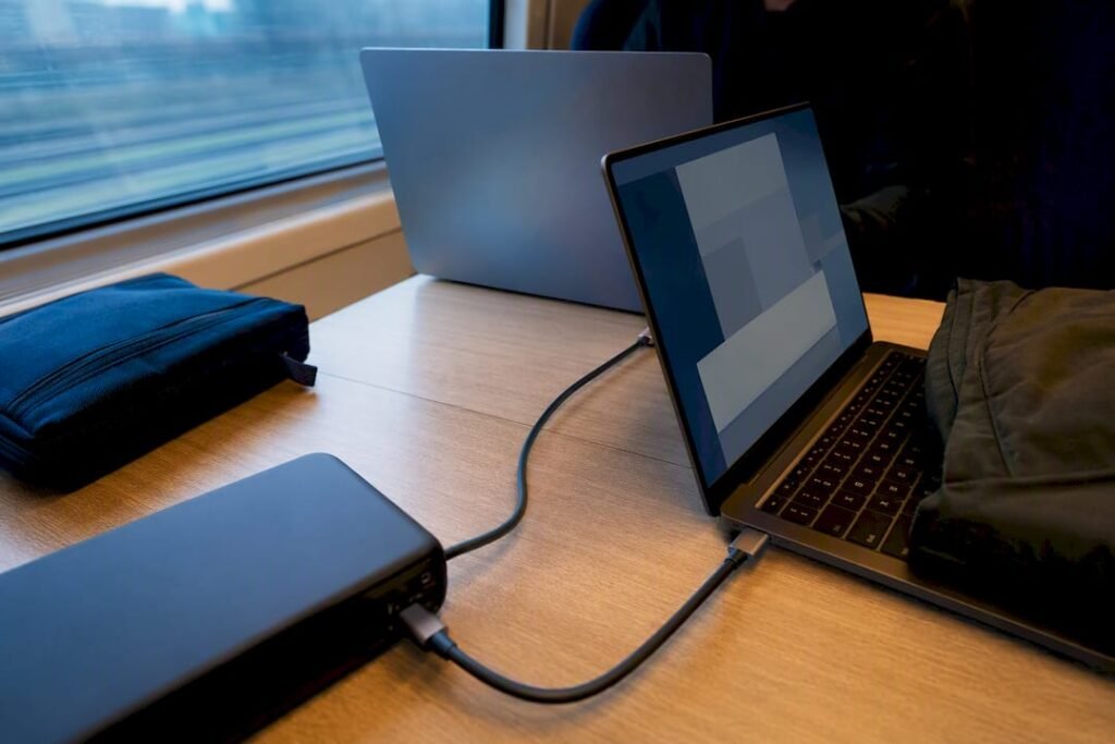Two laptops charging during train travel
